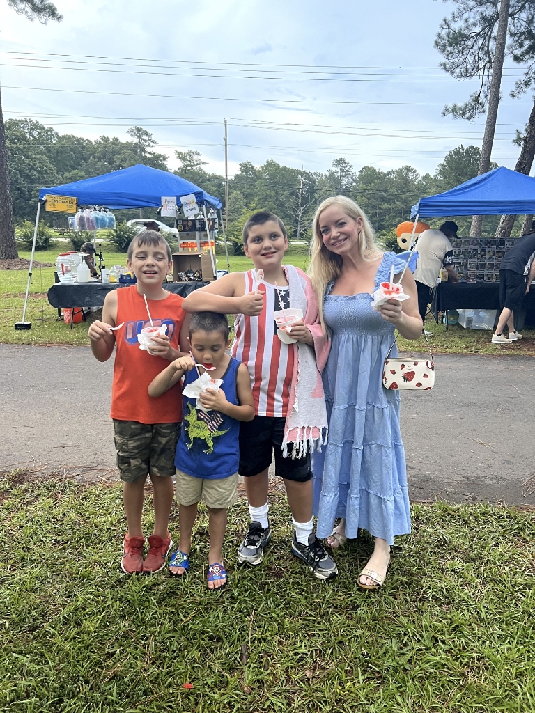 Patriotic family enjoying snoballs at outdoor community event